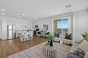 Maricopa apartment for rent - A modern kitchen with white cabinets and a dining area with a table and chairs at Copa Flats Apartments, Maricopa, Arizona