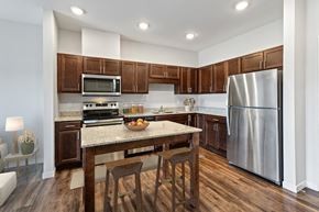 Rochester apartment for rent - a kitchen with stainless steel appliances and a granite counter top at EastGate Apartments, Rochester, MN