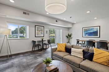 A living room with a couch and a table with chairs
