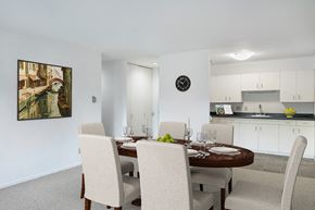 Saint Paul apartment for rent - a dining room with a table and chairs and a kitchen at Humboldt Senior 55+ Apartments, Saint Paul, MN, 55107