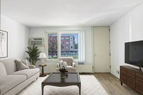 Saint Paul apartment for rent - a living room with a couch and a coffee table at Humboldt Senior 55+ Apartments, Saint Paul