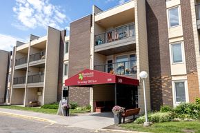 Saint Paul apartment for rent - an apartment building with a red awning in front of it at Humboldt Senior 55+ Apartments, Minnesota