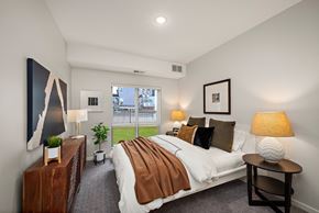 Rosemount apartment for rent - A bedroom with a large bed and a painting on the wall at The Landing at Amber Fields Apartments, Minnesota