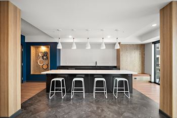A modern kitchen with a bar stool.