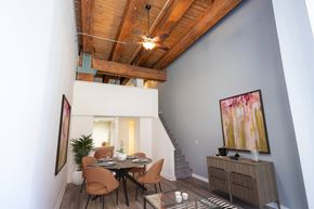 St. Paul apartment for rent - a dining room with a table and chairs and a ceiling with wooden beams at Lowertown Commons Apartments, St. Paul, MN