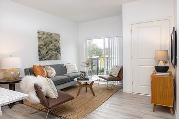 Maplewood apartment for rent - a living room with a couch and chairs and a door to a balcony