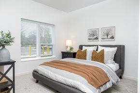Maplewood apartment for rent - a bedroom with a bed and two windows
