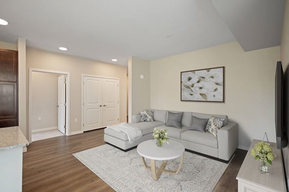Hastings apartment for rent - a living room with a couch and a table at The Quill 55+ Apartments, Hastings, 55033