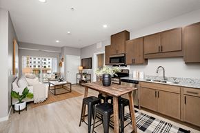 Woodbury apartment for rent - A kitchen with a table and chairs in the middle of the room.