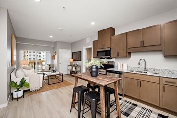 Woodbury apartment for rent - A kitchen with a table and chairs in the middle of the room.