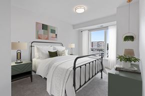 Coon Rapids apartment for rent - a bedroom with a large bed and a window