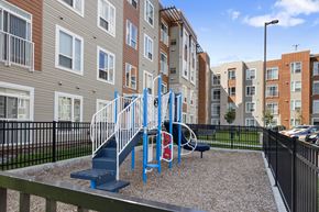 Coon Rapids apartment for rent - a blue playground in front of an apartment building