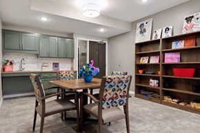 Brooklyn Center apartment for rent - A kitchen with a table and chairs and a shelf with bowls on it at Sonder Point 50+ Apartments, MN
