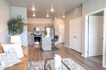 Rochester apartment for rent - a living room and kitchen with a couch and a table