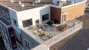 Lauderdale apartment for rent - arial view of a building with a balcony and tables and chairs
