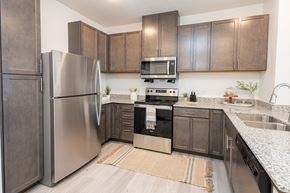 Mahtomedi apartment for rent - a kitchen with stainless steel appliances and wooden cabinets