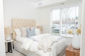 Mahtomedi apartment for rent - a bedroom with a large bed and a large window