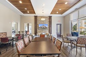 West St Paul apartment for rent - a dining room with a table and chairs and a fireplace at The Winslow 62+ Apartments, West St Paul, MN, 55118