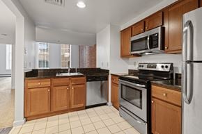 St. Paul apartment for rent - A kitchen with a black granite countertop and stainless steel appliances. at Parkside Apartments, St. Paul