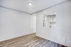 Winnipeg apartment for rent - A room with a white wall and a wooden floor.
