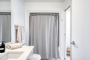Winnipeg apartment for rent - A bathroom with a white sink and a shower curtain.