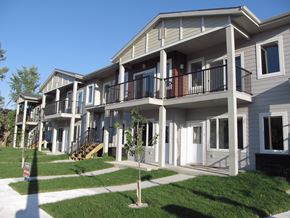 Winnipeg apartment for rent - a row of houses with balconies and grass