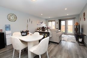 Ile Des Chenes townhouse for rent - A dining room with a white table and chairs.