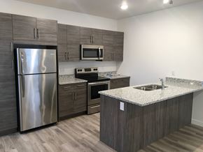 Winnipeg apartment for rent - a kitchen with stainless steel appliances and granite counter tops