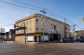 Winnipeg apartment for rent - A street view of a building with a sign that says "Pop. Pick".