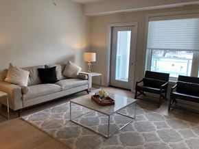 Winnipeg apartment for rent - a living room with couches and a glass coffee table