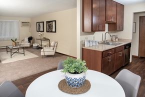 Anoka apartment for rent - a dining room table with a vase on top of it next to a kitchen