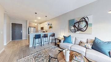 Cottage Grove apartment for rent - a living room with a couch and a kitchen with a bar