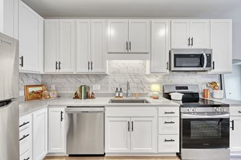 A modern kitchen with stainless steel appliances.