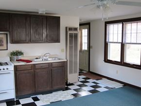 Medicine Lake apartment for rent - a kitchen with a black and white checkered floor and a stove and sink