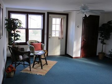 Medicine Lake apartment for rent - a living room with a table and chairs and a ceiling fan