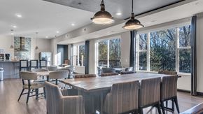 Minnetonka apartment for rent - A modern dining room with a long table and chairs.