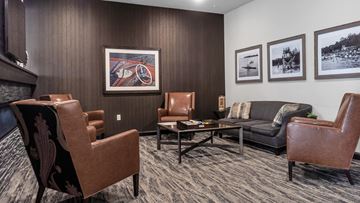 Minnetonka apartment for rent - A living room with brown leather chairs and a grey couch.