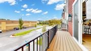 Champlin townhouse for rent - A balcony with a view of a parking lot and trees.at Field and Grove Townhomes of Champlin, Champlin, MN 55316