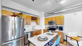 Minneapolis apartment for rent - A kitchen with a table set for two and a refrigerator.