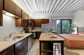 Minneapolis apartment for rent - A kitchen with wooden cabinets and a white ceiling at The Cameron North Loop, Minneapolis, MN 55401