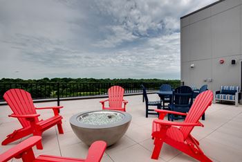 Rooftop patio with firepit, grills and seating overlooking lake jonathan