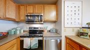 Minneapolis apartment for rent - a kitchen with stainless steel appliances and wooden cabinets at Bierman Place, Minneapolis, 55414