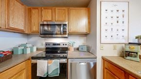 Minneapolis apartment for rent - a kitchen with stainless steel appliances and wooden cabinets at Bierman Place, Minneapolis, 55414