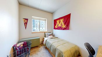 A bedroom with a bed and a window