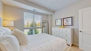 Long Lake apartment for rent - a white bedroom with a large bed and a window