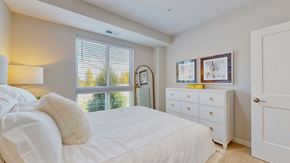 Long Lake apartment for rent - a white bedroom with a large bed and a window