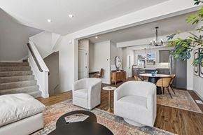 Blaine townhouse for rent - A living room with a staircase and a dining table.