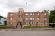 Minneapolis apartment for rent - a large brick building with a flagpole in front of it
