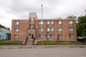 Minneapolis apartment for rent - a large brick building with a flagpole in front of it