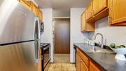 Minneapolis apartment for rent - a kitchen with wooden cabinets and stainless steel appliances